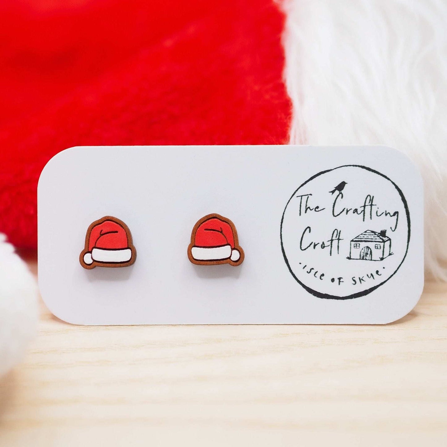 Santa hat studs made from solid cherry wood, hand painted, eco-friendly finish, mounted on surgical steel posts, in gift box.