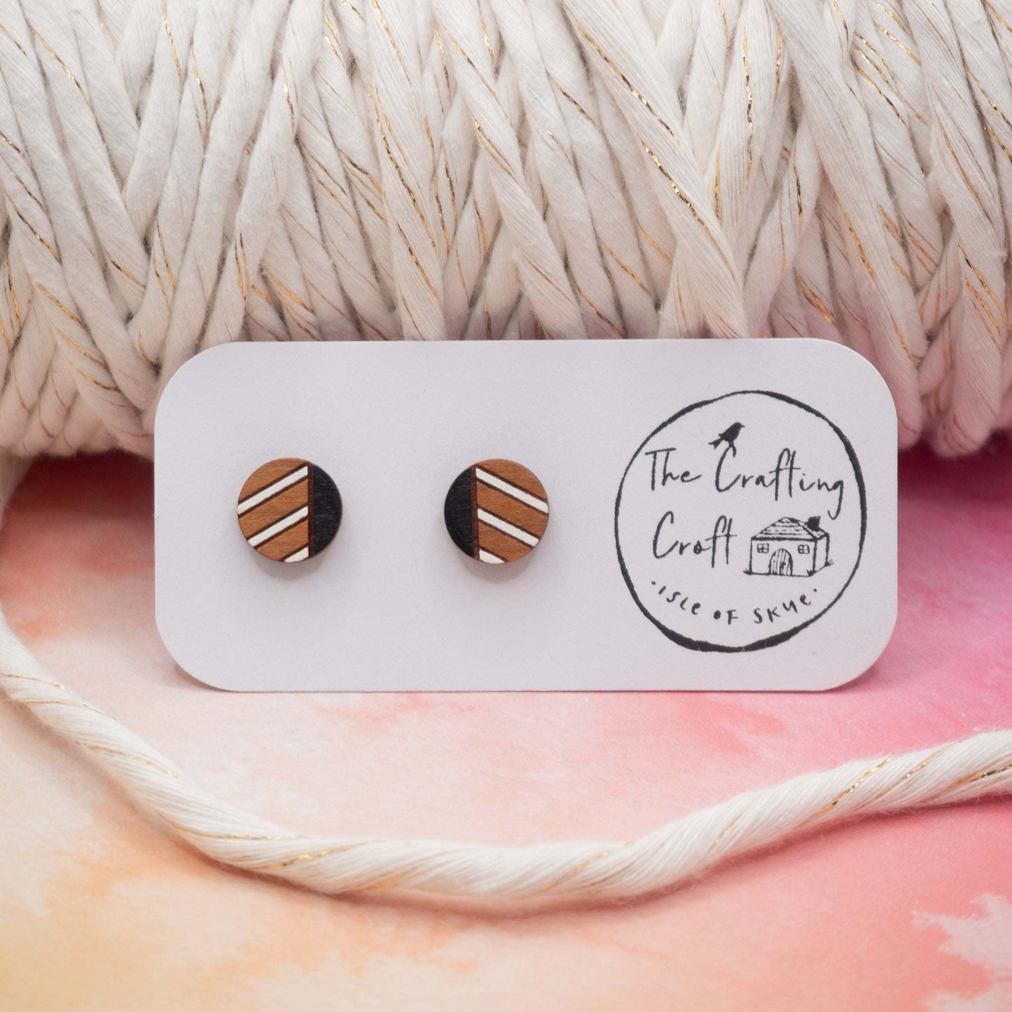 Monochrome geometric painted stud earrings made from cherry wood with black and white stripes.