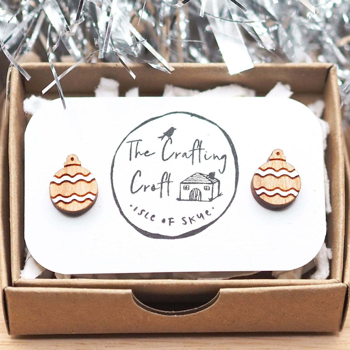 Silver Christmas bauble earrings in eco-friendly packaging with festive design.