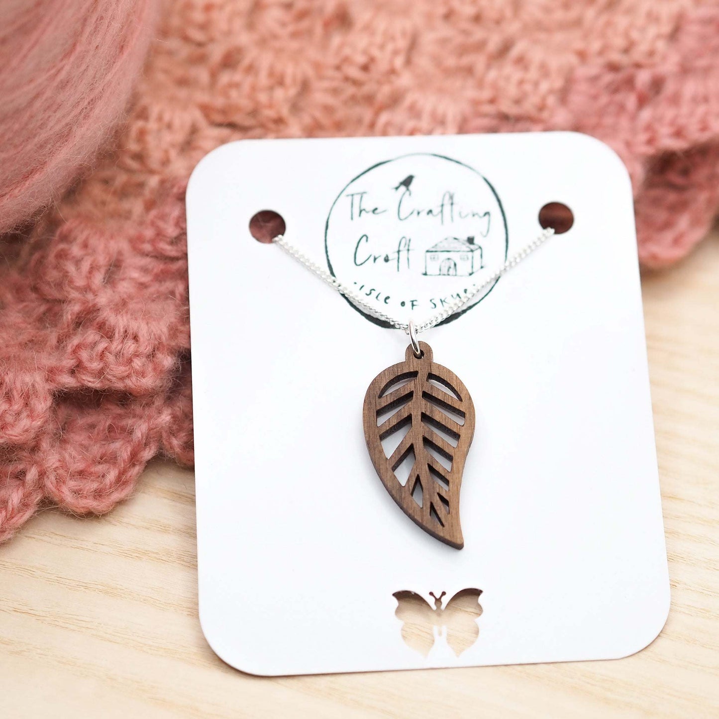 Eco-friendly leaf outline necklace with walnut wood pendant on recycled sterling silver chain.