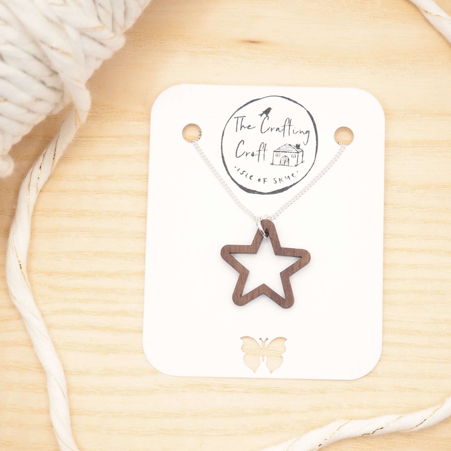 Chunky star necklace with wooden star pendant and recycled silver chain, presented in eco-friendly packaging.