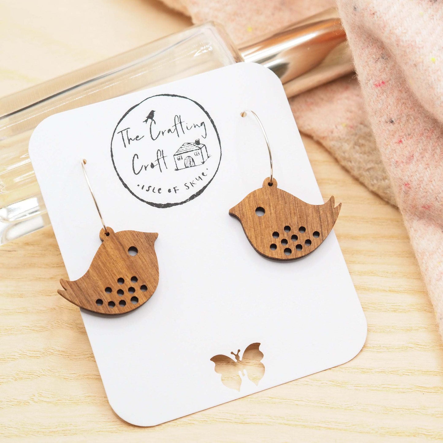 Quirky bird engraved walnut wood hoop earrings with sterling silver hoops.