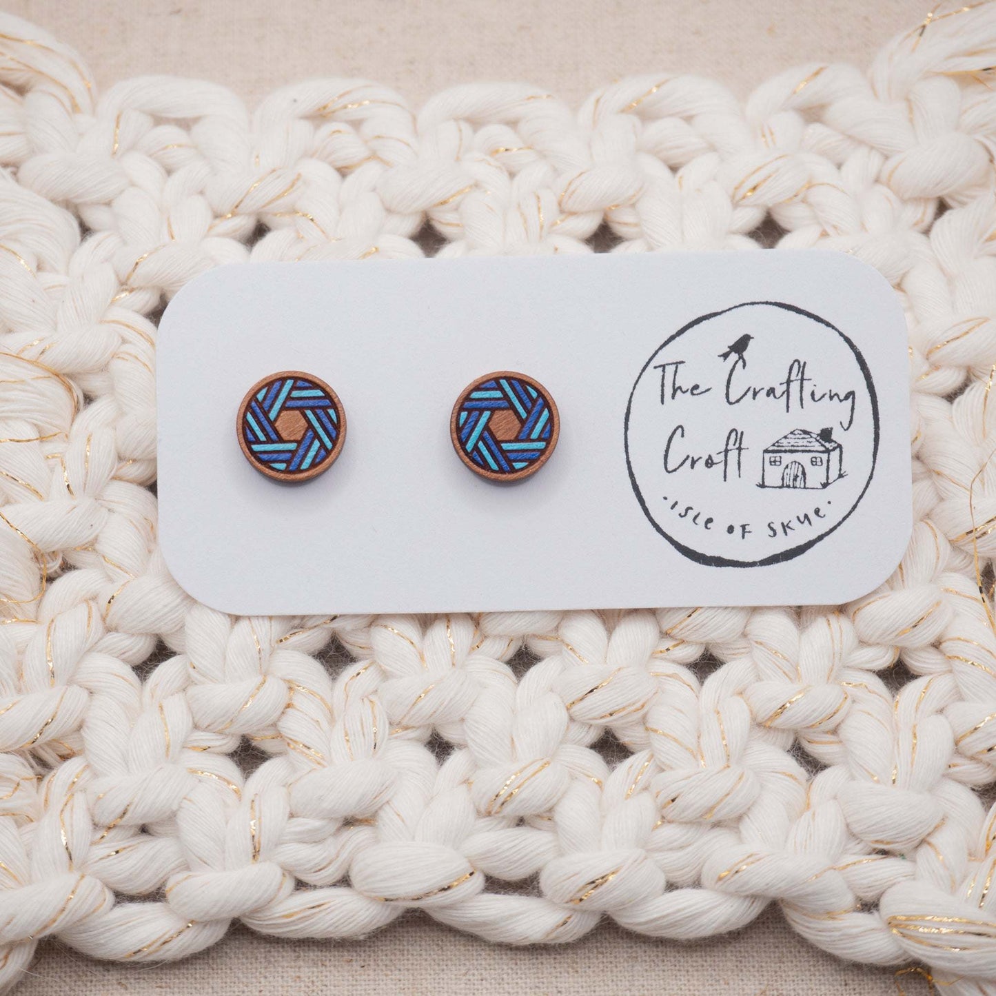 Blue knot painted stud earrings on a card with crafting logo, showcasing their unique laser-cut design and vibrant color.
