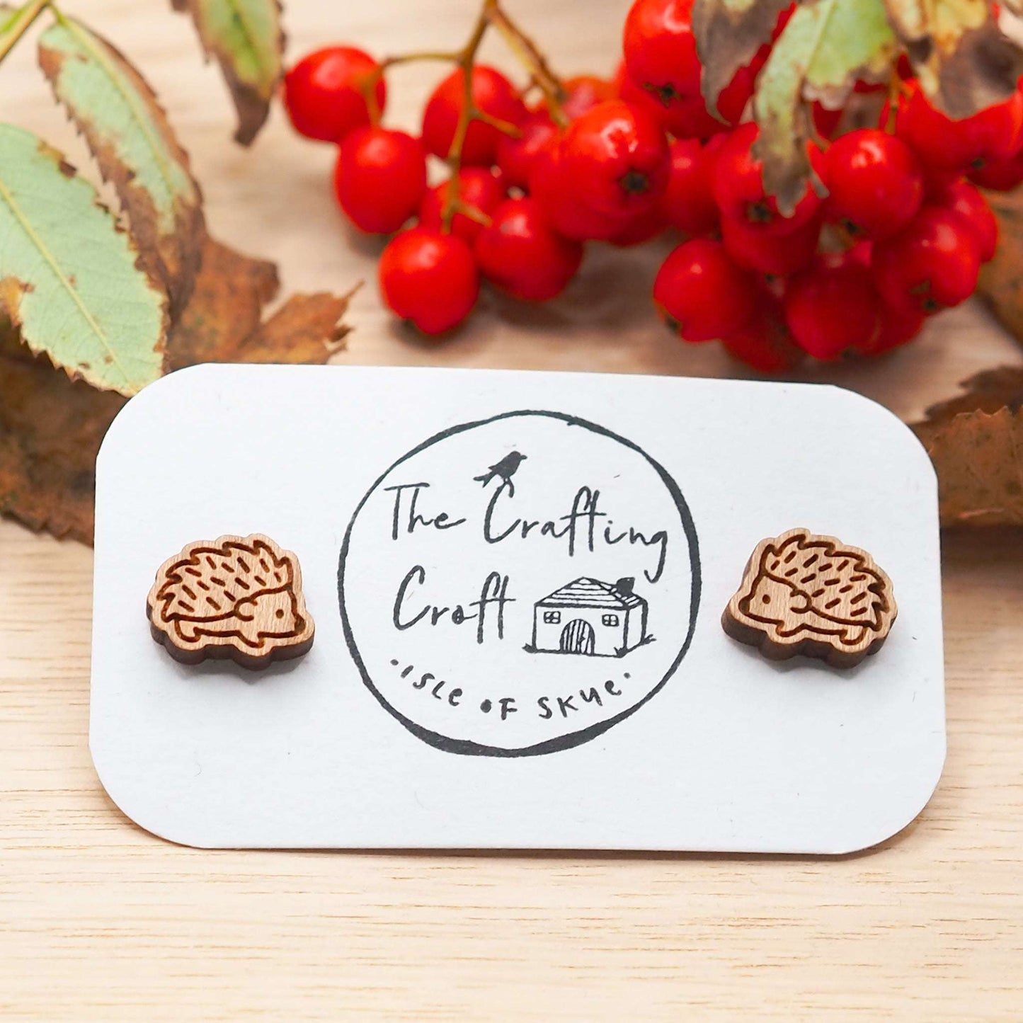 Wooden hedgehog stud earrings with laser-cut design and surgical steel backs.