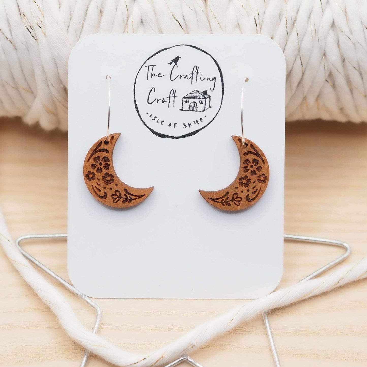 Wooden moon engraved hoop earrings with sterling silver hoops, laser cut from cherry wood, featuring a folksy engraved pattern.