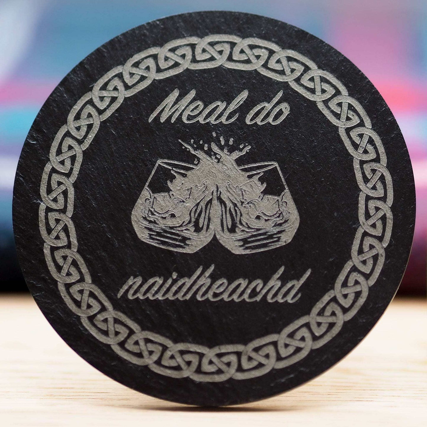 Gaelic congratulations slate coaster with "Meal do naidheachd" engraving and Celtic band design.