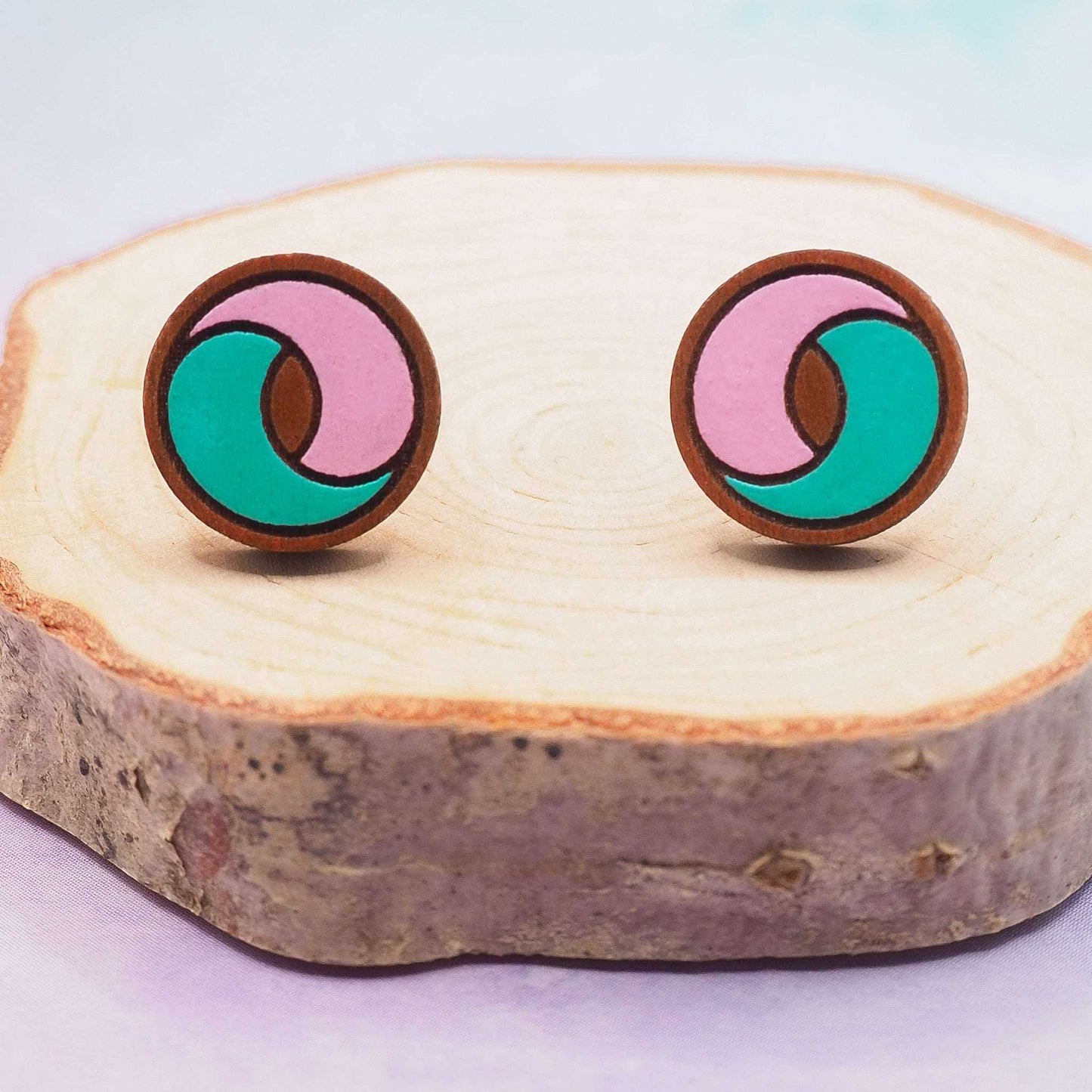 Pink and turquoise swirl stud earrings on sustainable cherry wood.