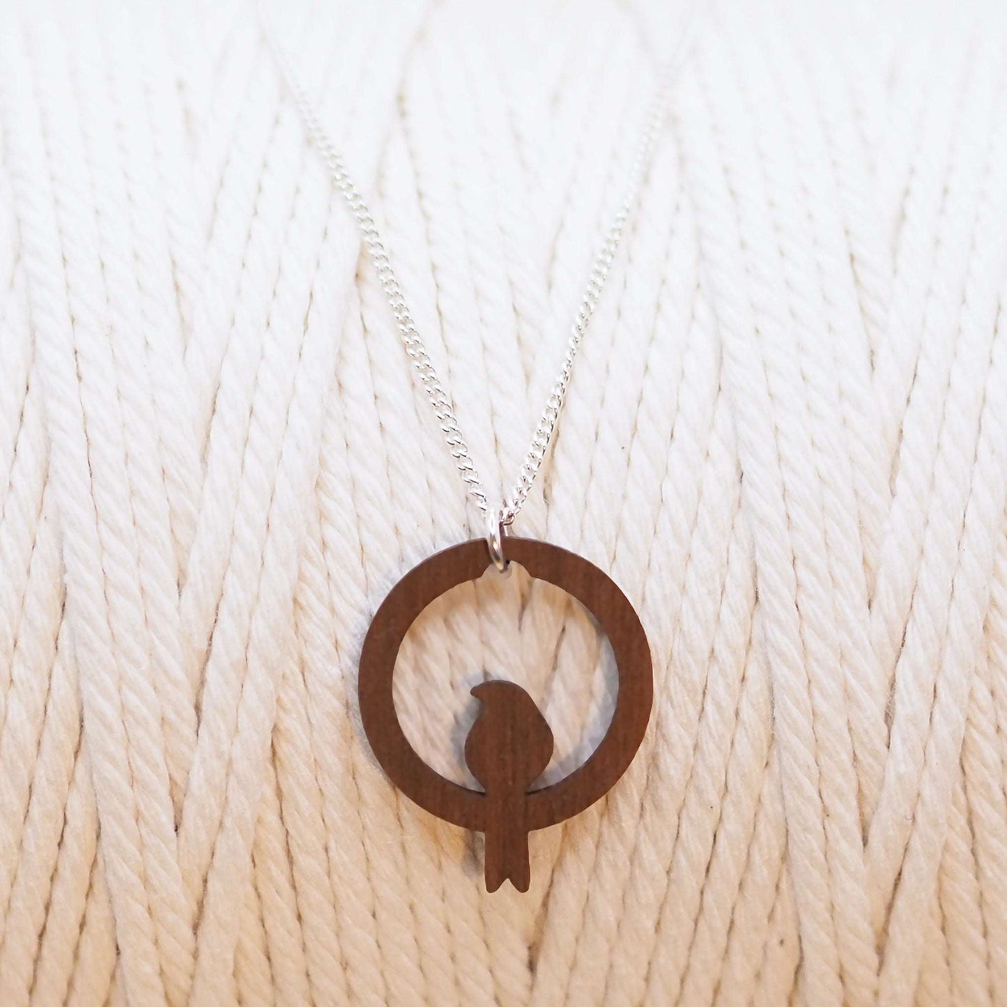 Wooden bird hoop necklace on sterling silver chain.