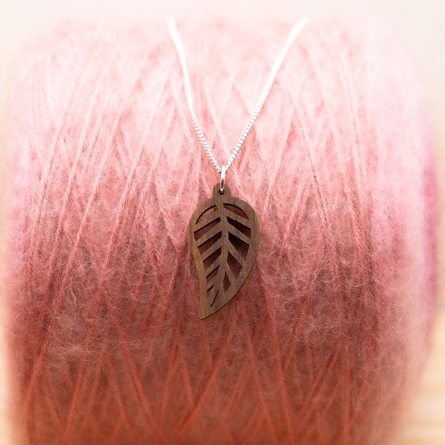 Walnut wood leaf outline necklace on recycled sterling silver chain.