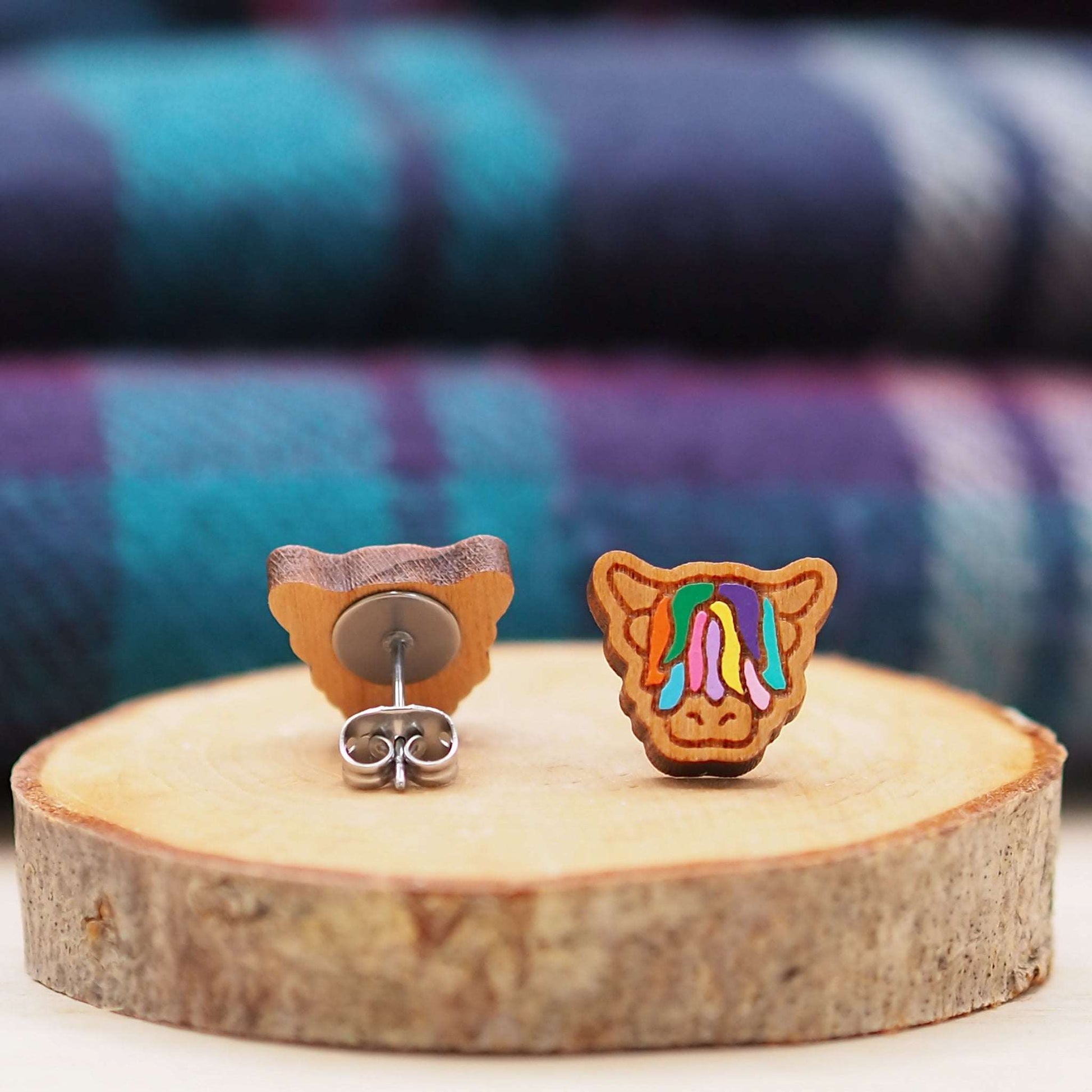 Multi-coloured Highland Cow stud earrings made from cherry wood with surgical steel backs, presented in a gift box.