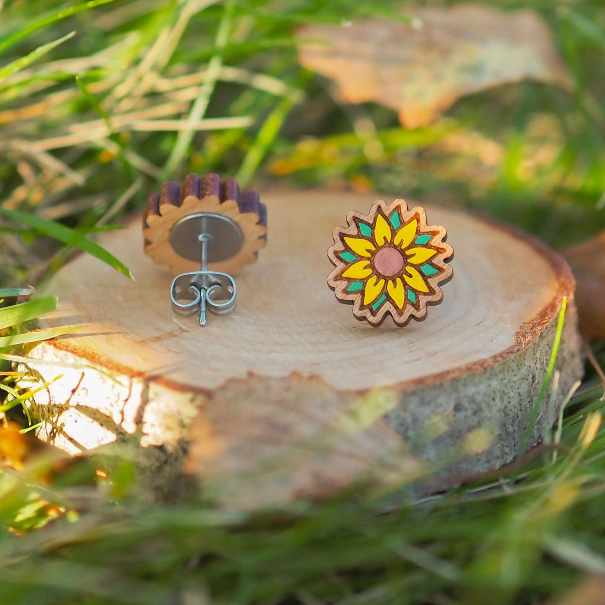 Hand-painted sunflower stud earrings on cherry wood with surgical steel backs.