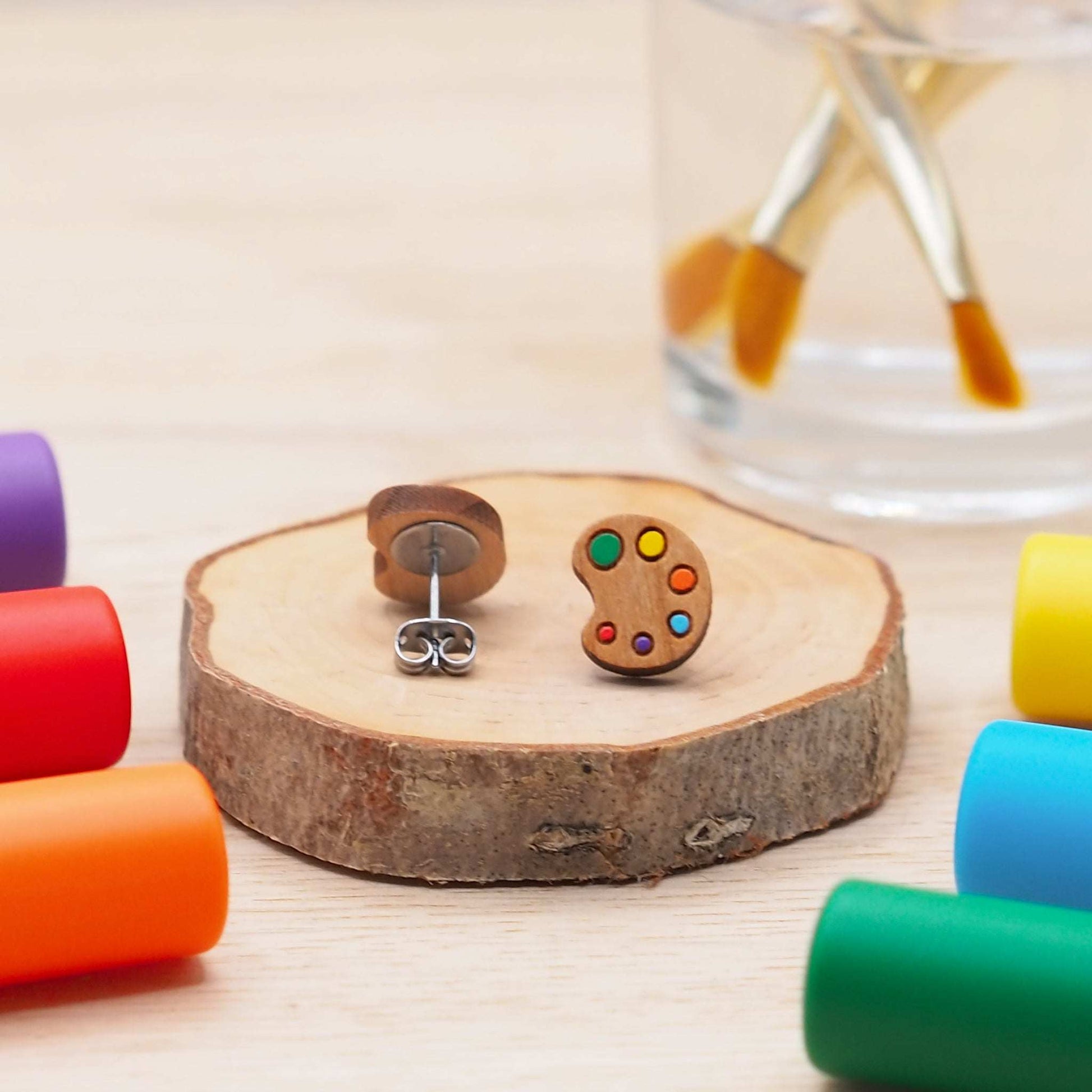 Cherry wood art palette stud earrings with multicolored design and surgical steel backs.