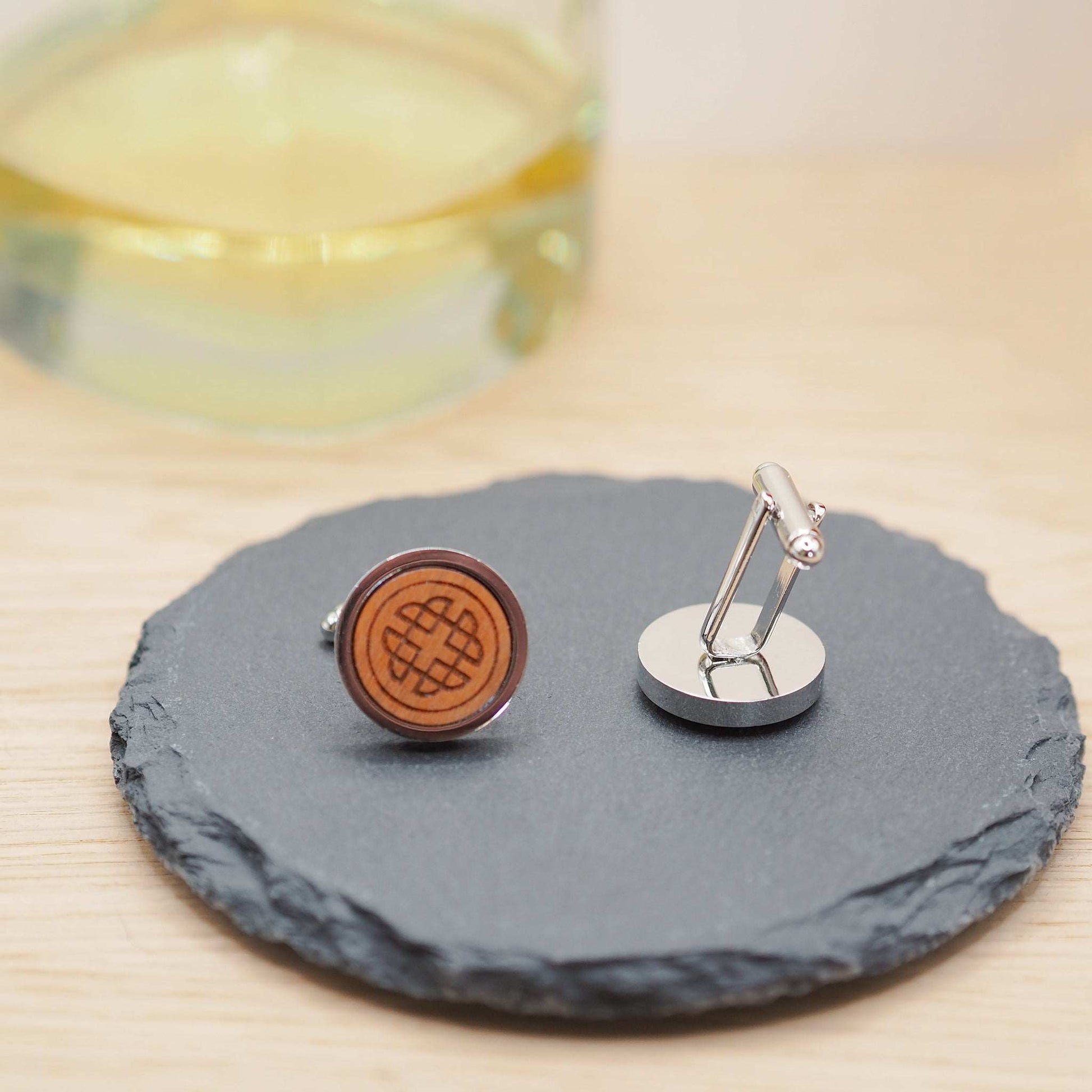 Intricate Celtic knot wooden cufflinks on slate tray, carved cherry wood set in silver rhodium bezels.