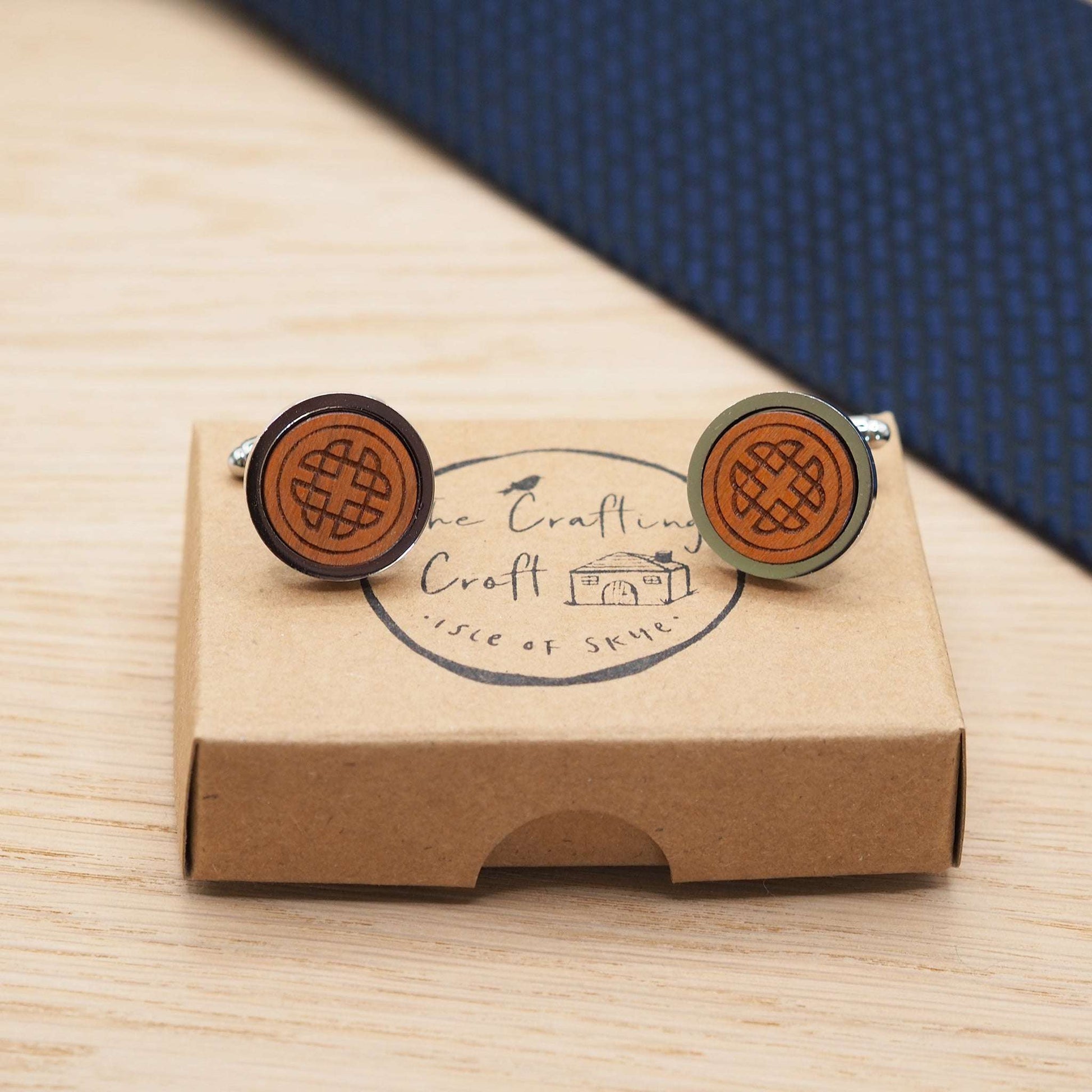 Intricate celtic knot wooden cufflinks engraved on cherry wood with silver rhodium bezels, displayed in eco-friendly box.