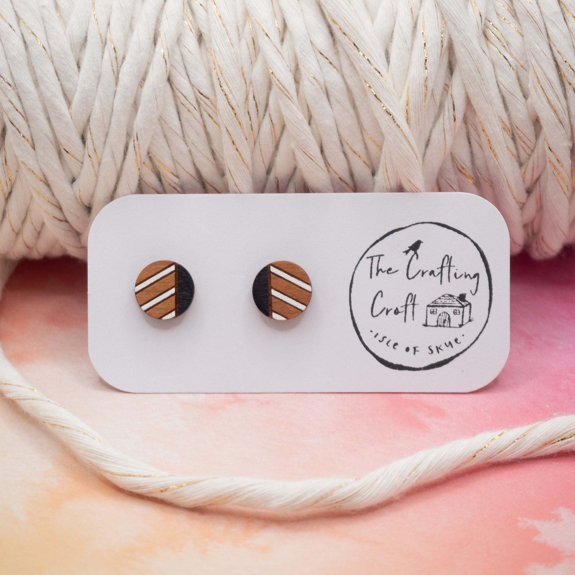 Monochrome geometric painted stud earrings made from cherry wood with black and white stripes.