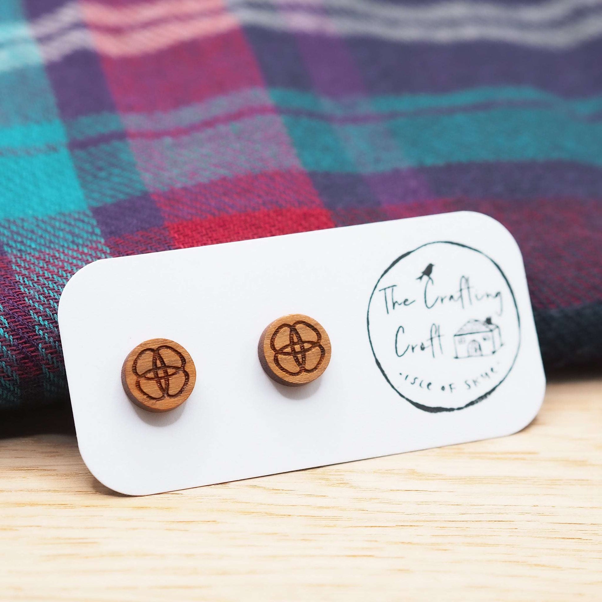 Celtic flower knot stud earrings made from solid cherry wood with engraved design and surgical steel backs, eco-friendly packaging.