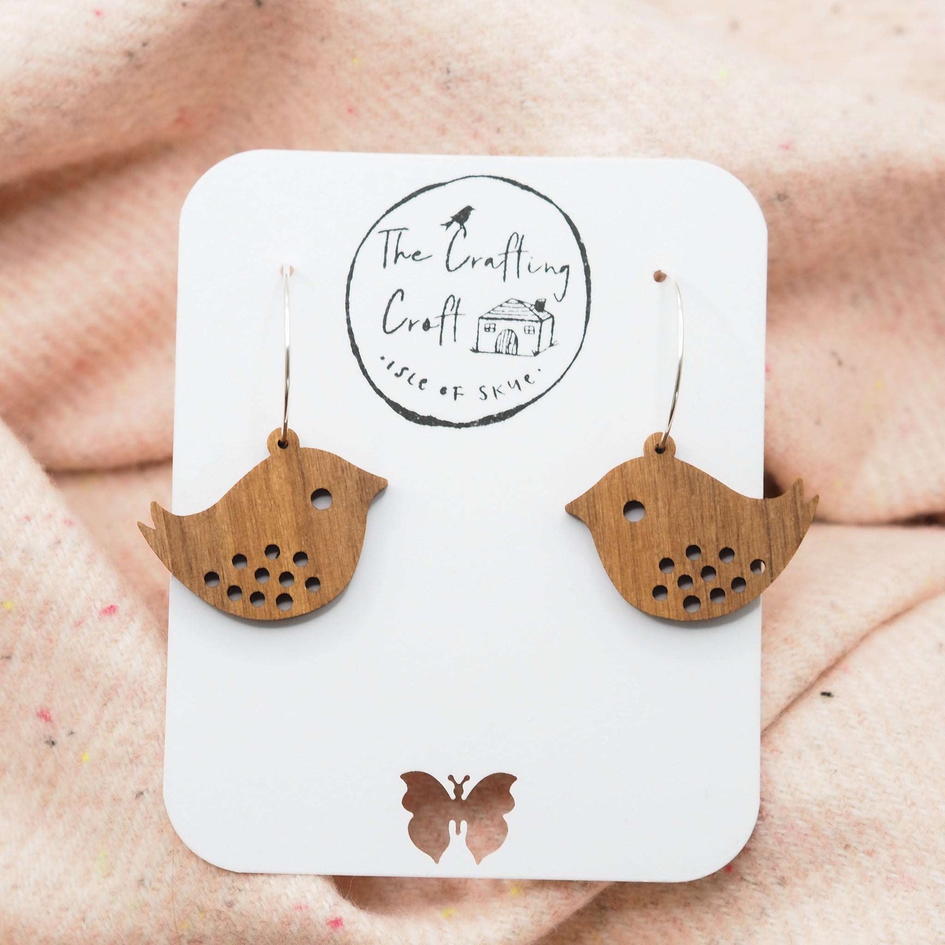 Quirky bird hoop engraved earrings made from sustainable walnut wood with sterling silver hoops, eco-friendly packaging.