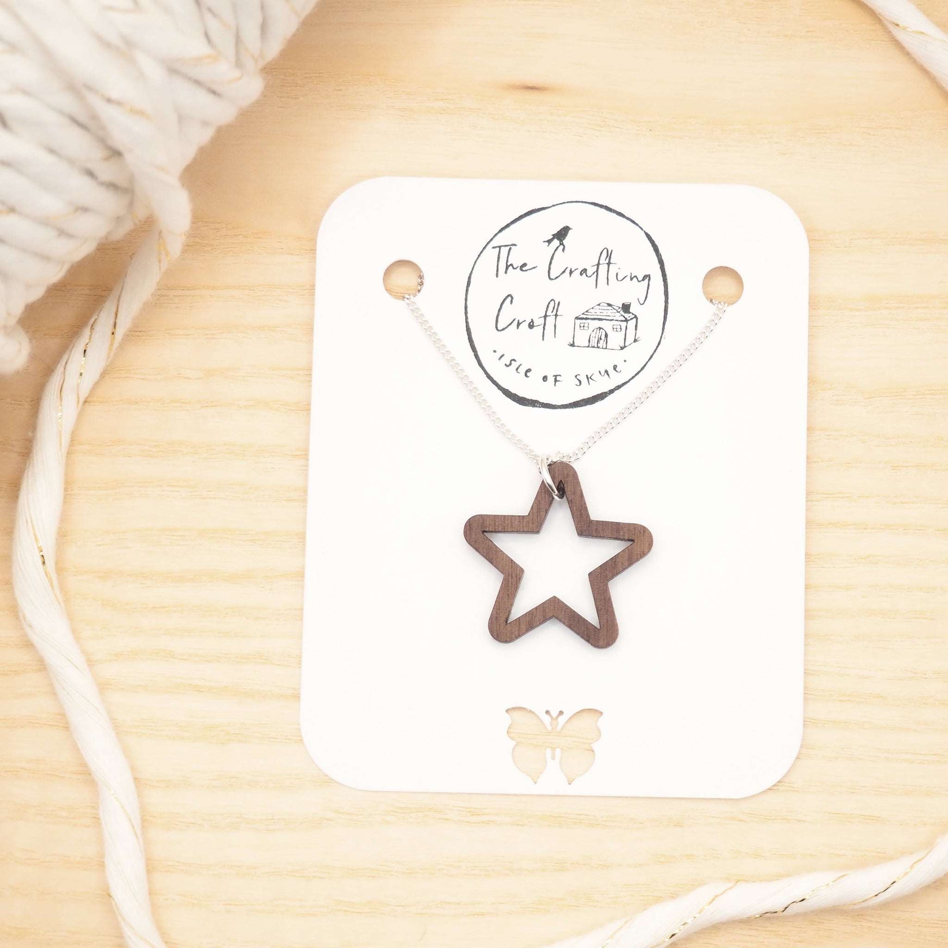 Chunky star necklace with wooden star pendant and recycled silver chain, presented in eco-friendly packaging.