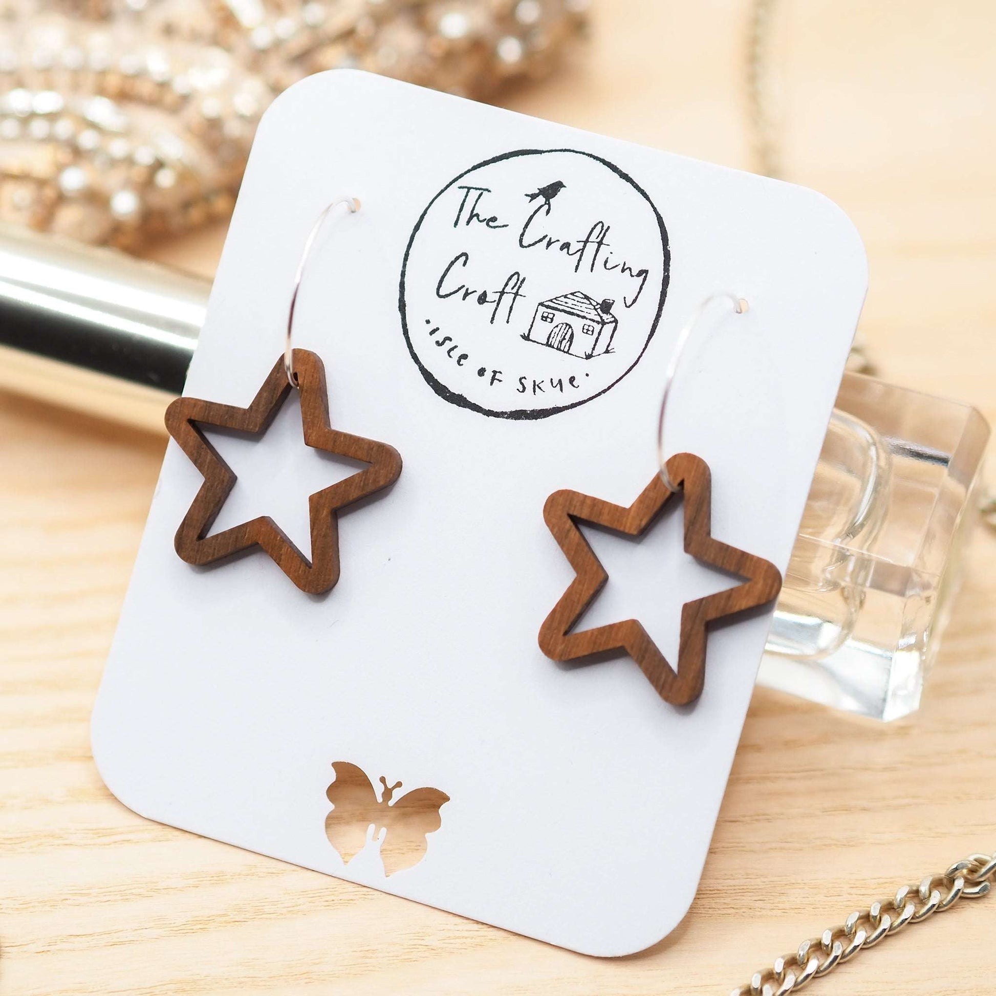 Chunky star hoop earrings made from sustainable walnut wood and sterling silver, eco-friendly packaging.