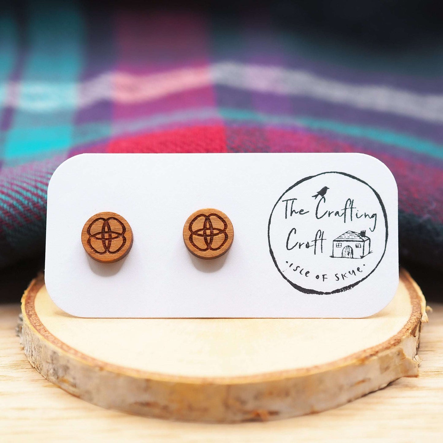 Celtic flower knot stud earrings made of cherry wood on a display card.