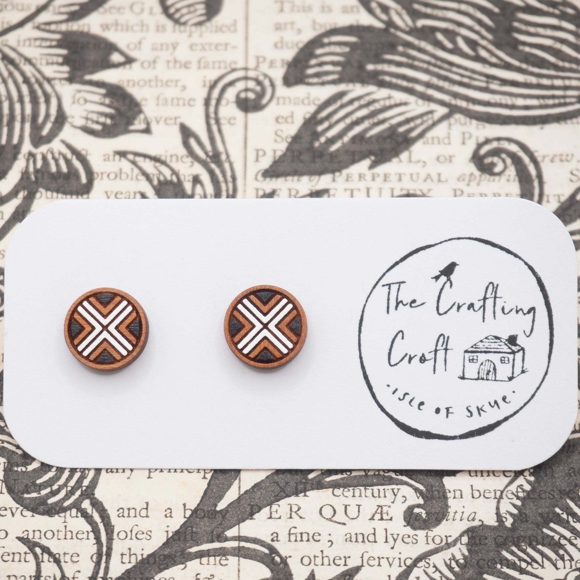 Black and white geometric painted studs made from cherry wood on decorative background, eco-friendly packaging.