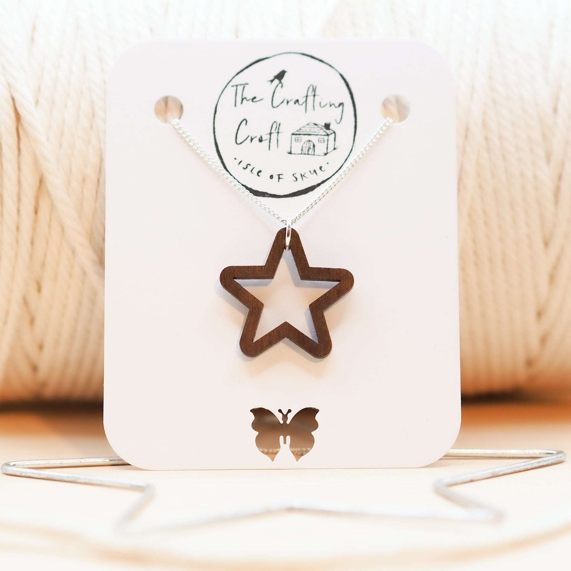 Chunky star necklace with wooden pendant on silver chain displayed in eco-friendly gift box.