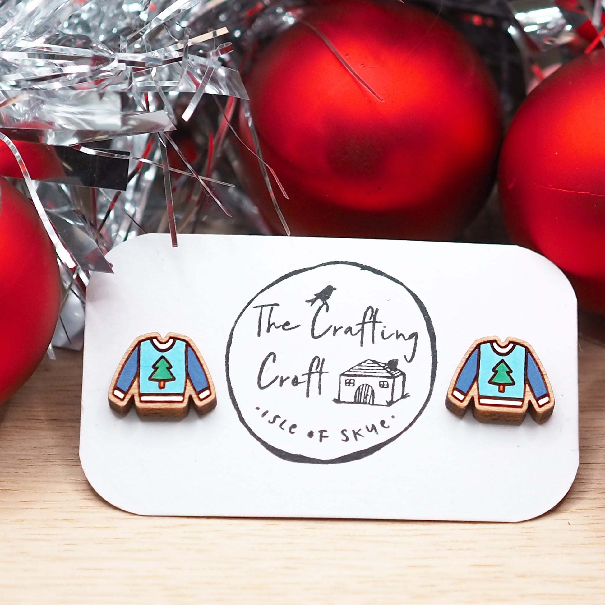 Christmas jumper stud earrings on card, hand-painted cherry wood, holiday theme, surgical steel posts, festive gift-ready.