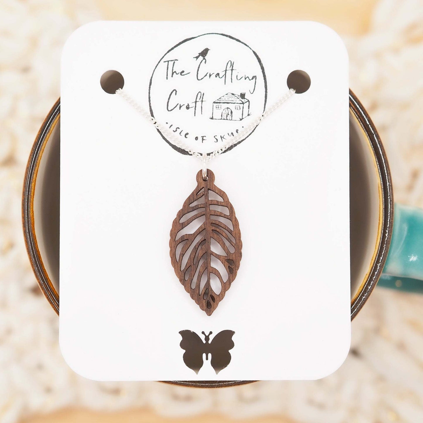 Leaf skeleton necklace on recycled sterling silver chain with walnut wood pendant.