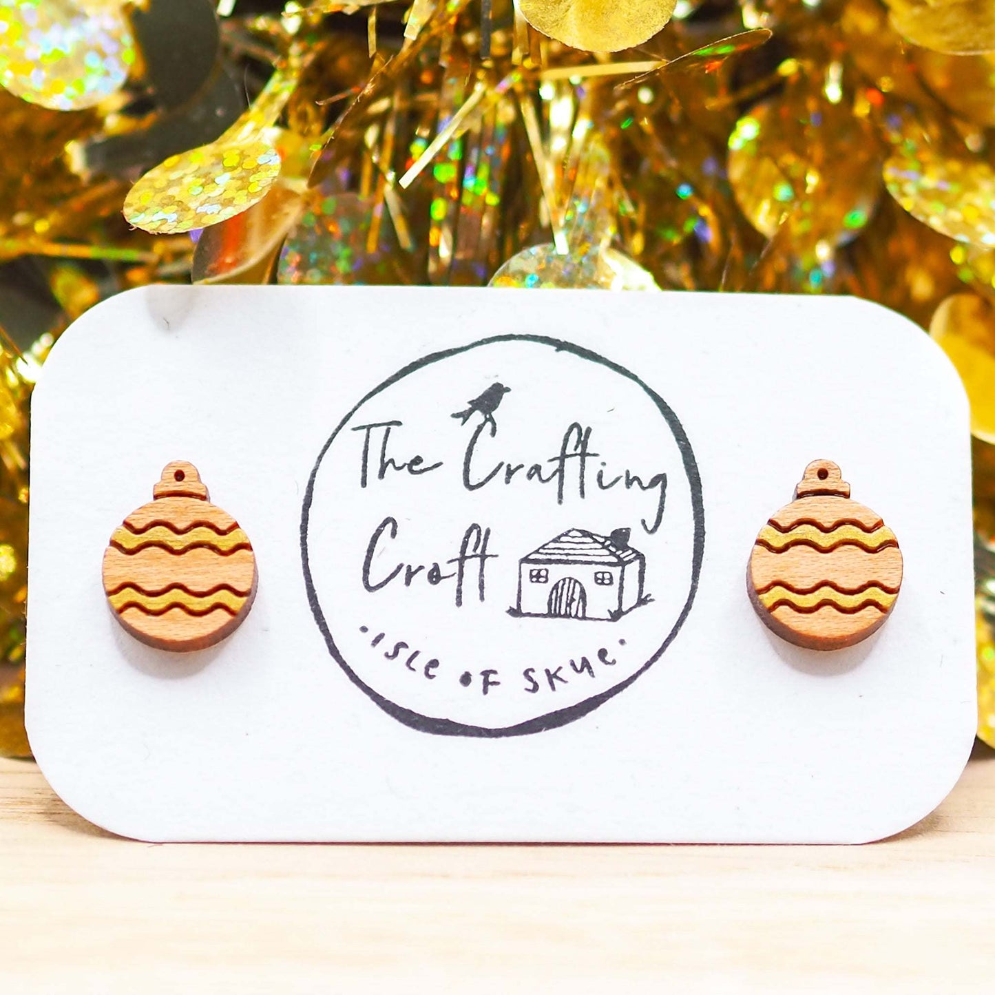 Gold Christmas bauble earrings on display card, handmade from cherry wood with gold pattern, festive holiday jewelry gift.