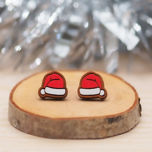 Santa hat studs made from cherry wood on a wooden display.