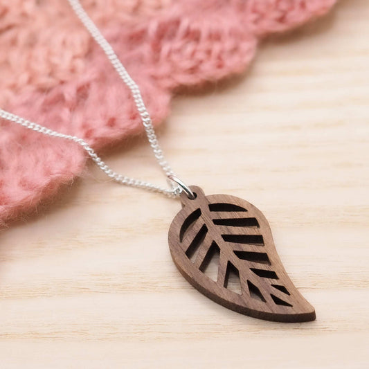 Leaf outline necklace made from walnut wood with recycled sterling silver chain.