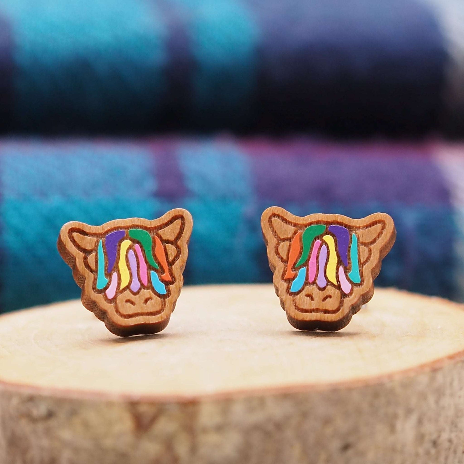 Multi-coloured Highland Cow stud earrings made from cherry wood with vibrant hand-painted design.