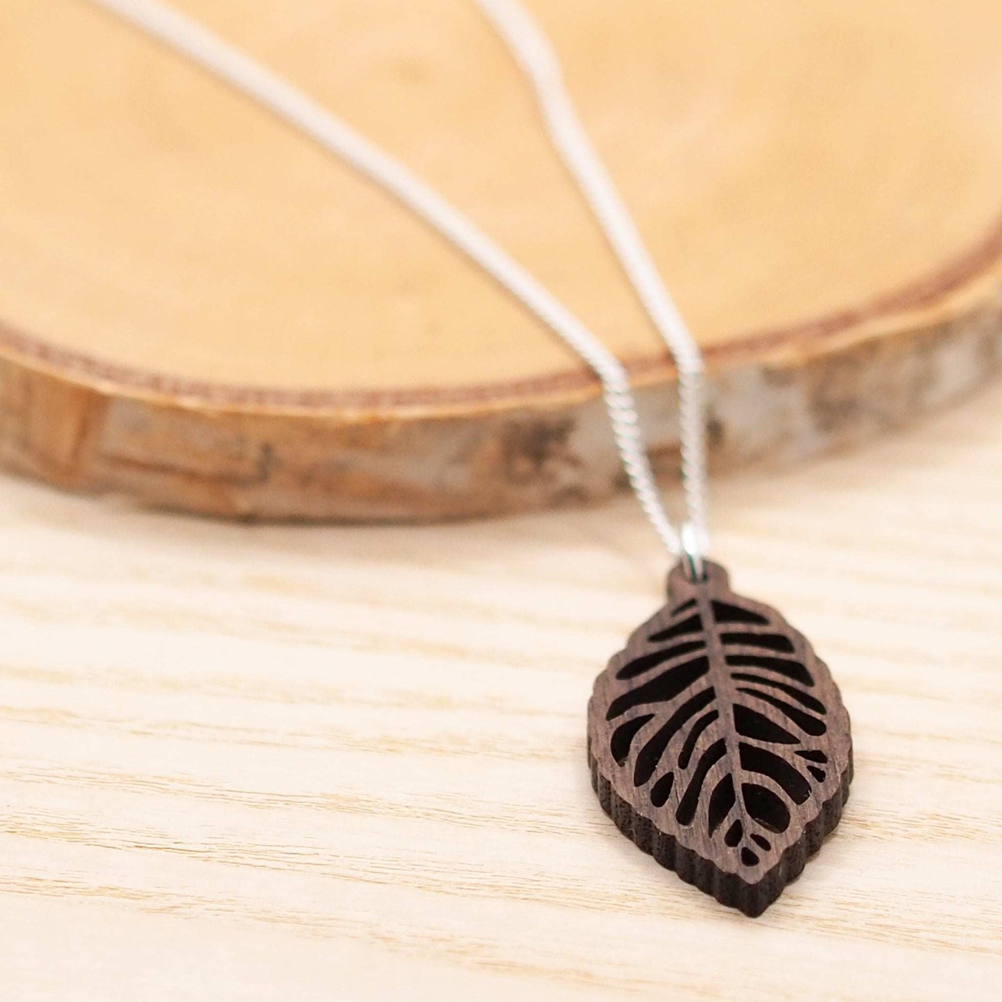 Sustainably sourced walnut wood leaf skeleton necklace on 18-inch recycled sterling silver chain.