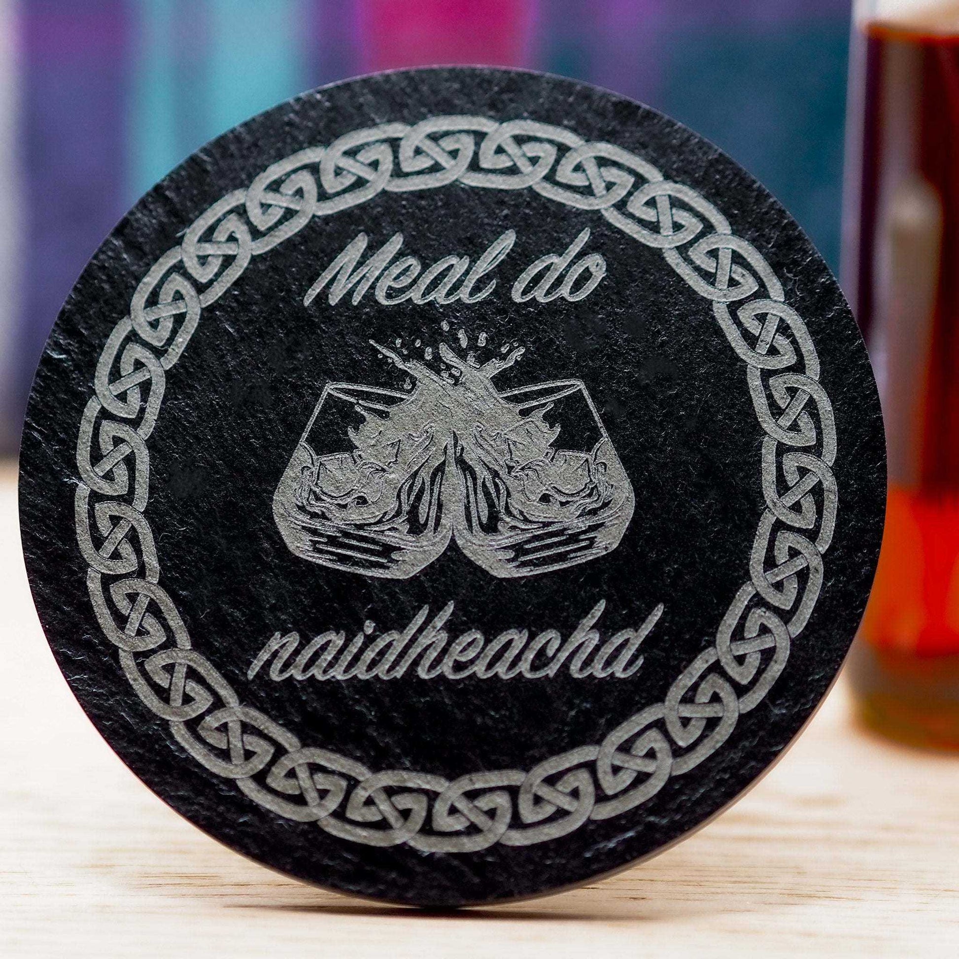 Gaelic congratulations slate coaster with Celtic design and "Meal do naidheachd" engraving.