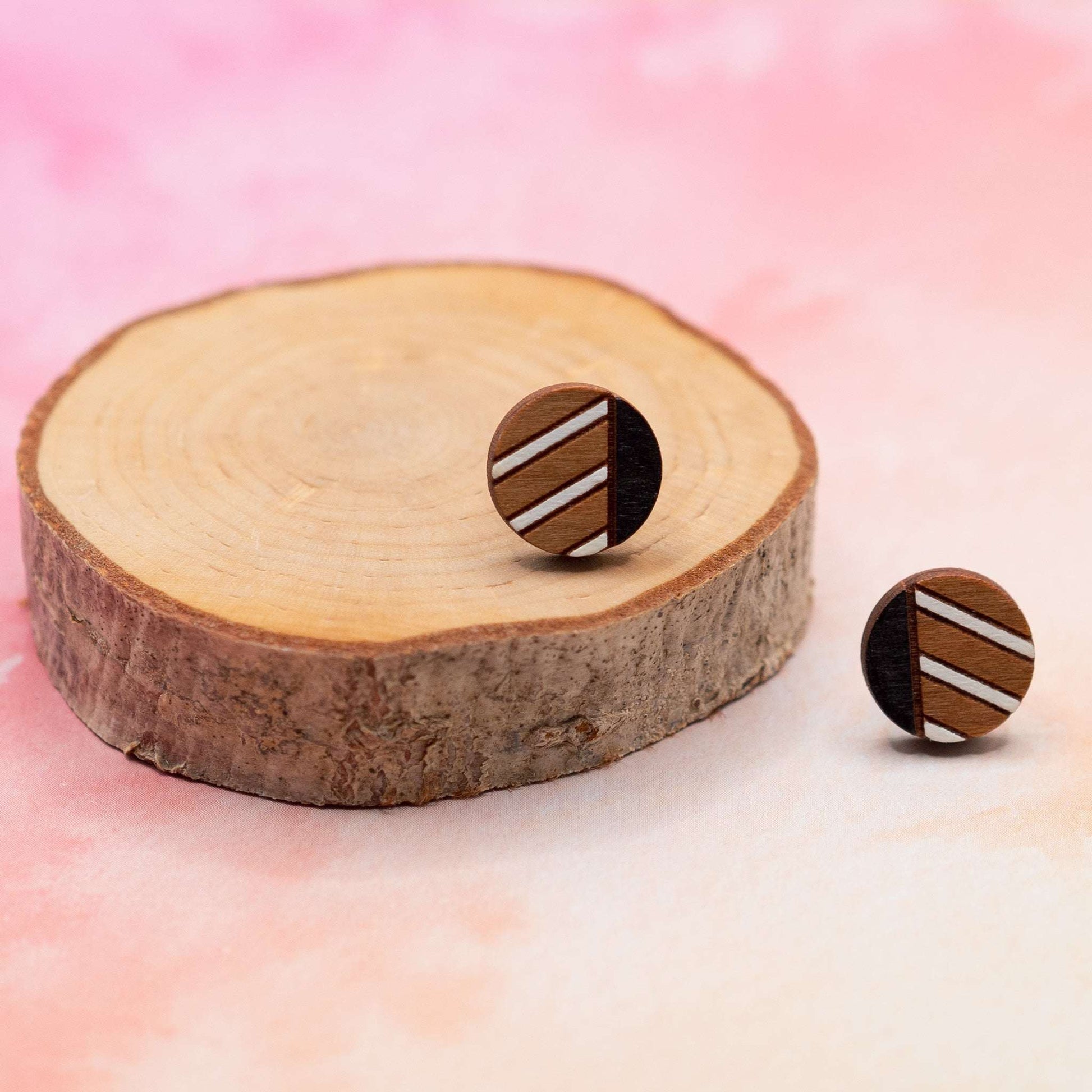 Monochrome geometric painted stud earrings made of cherry wood with black and white stripes, eco-friendly and handcrafted.