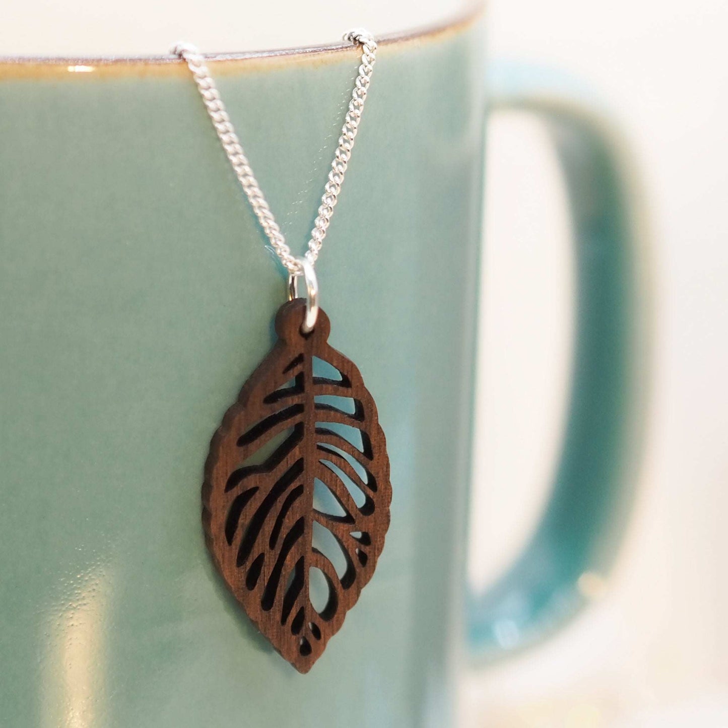 Leaf skeleton necklace with walnut wood pendant on recycled sterling silver chain.