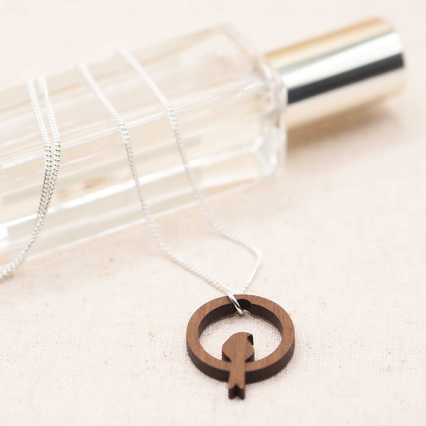 Wooden bird hoop necklace on a recycled sterling silver chain.