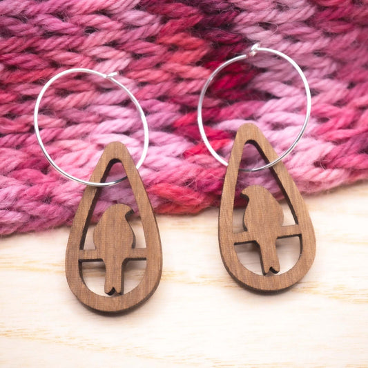 Perching bird teardrop hoop earrings made from walnut wood with sterling silver hoops.