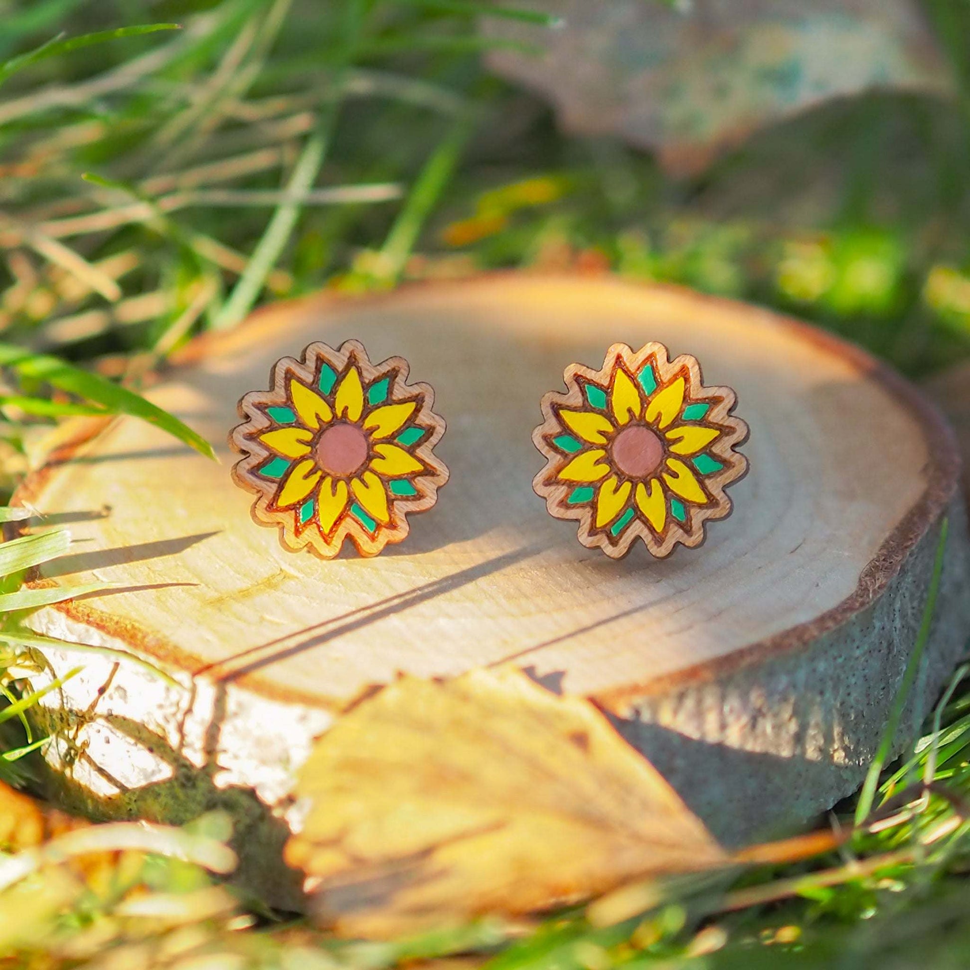 Hand painted sunflower stud earrings on cherry wood with surgical steel backs.