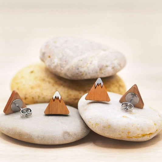 Hand-painted mountain stud earrings made from solid cherry wood with surgical steel backs, displayed on stones.