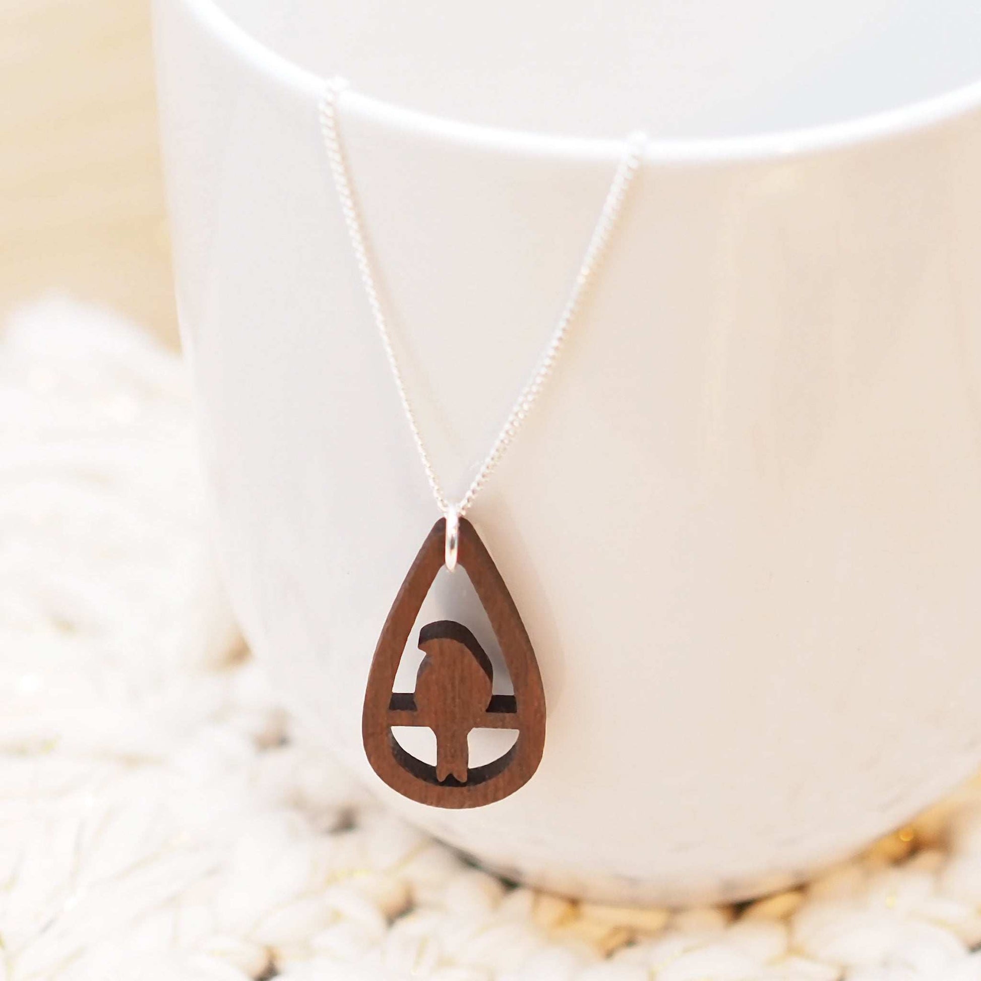 Bird teardrop necklace made from walnut wood on sterling silver chain.