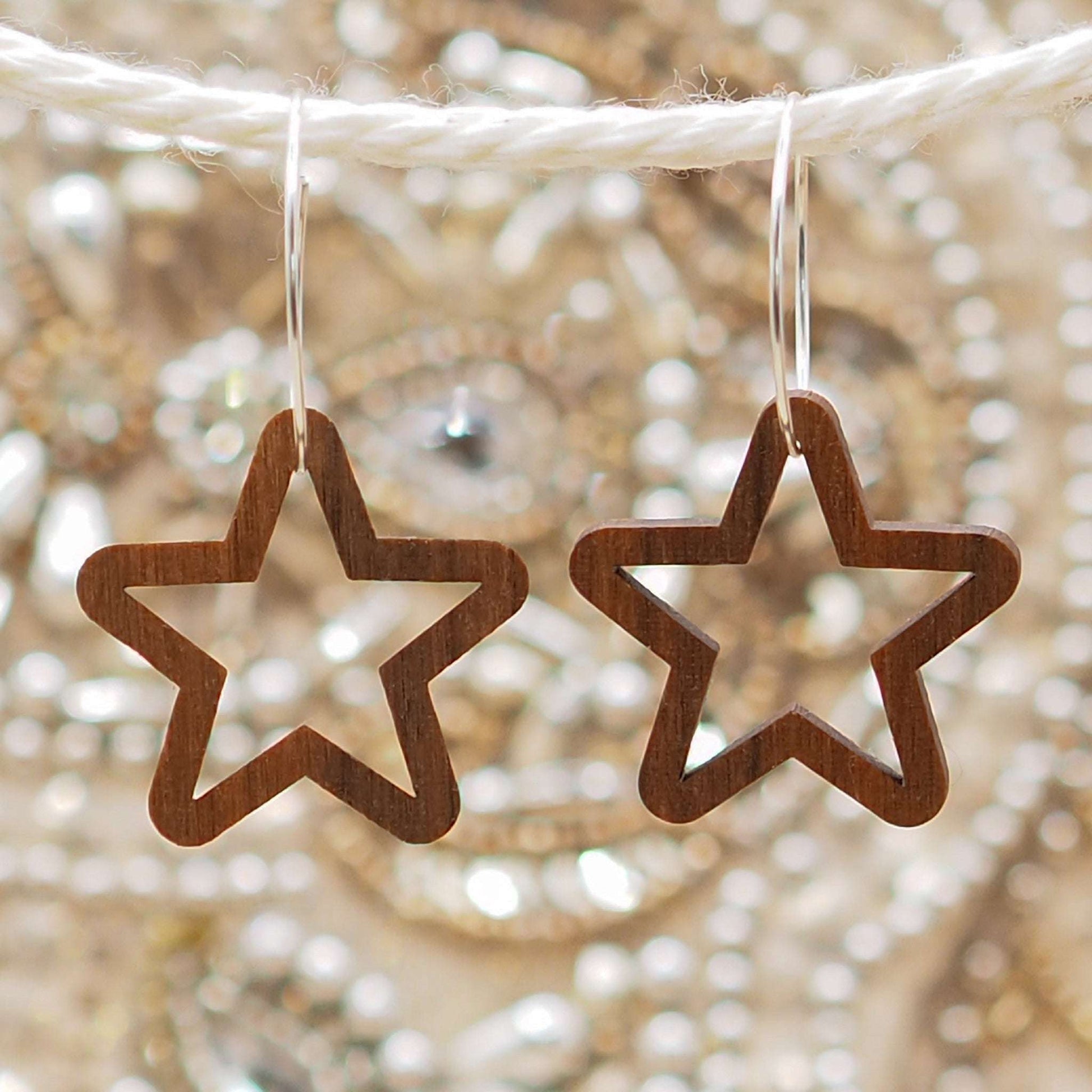 Chunky star hoop earrings made from sustainable walnut wood with sterling silver hoops.